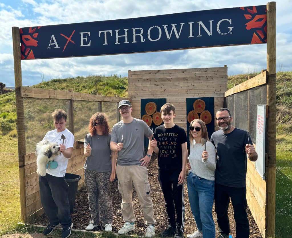 Group taking part in axe throwing experience at Wild Cairns