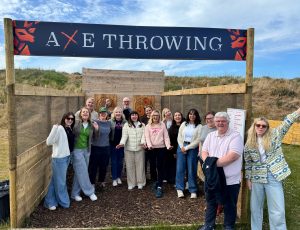 large group doing Axe throwing at wild cairns.