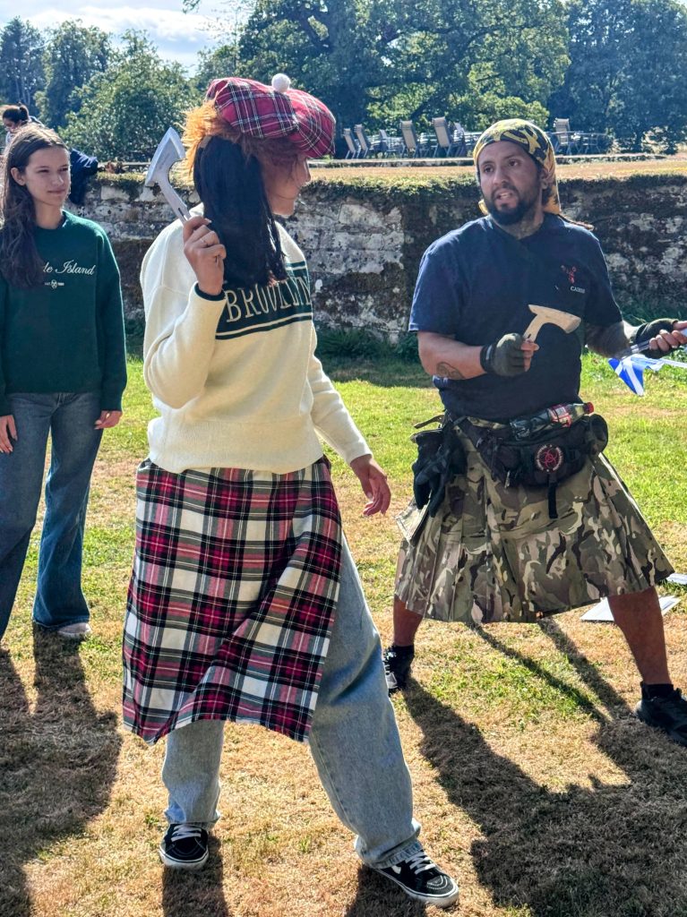 Wild Cairns instructor demonstrating axe throwing during a Mobile Highland Games event