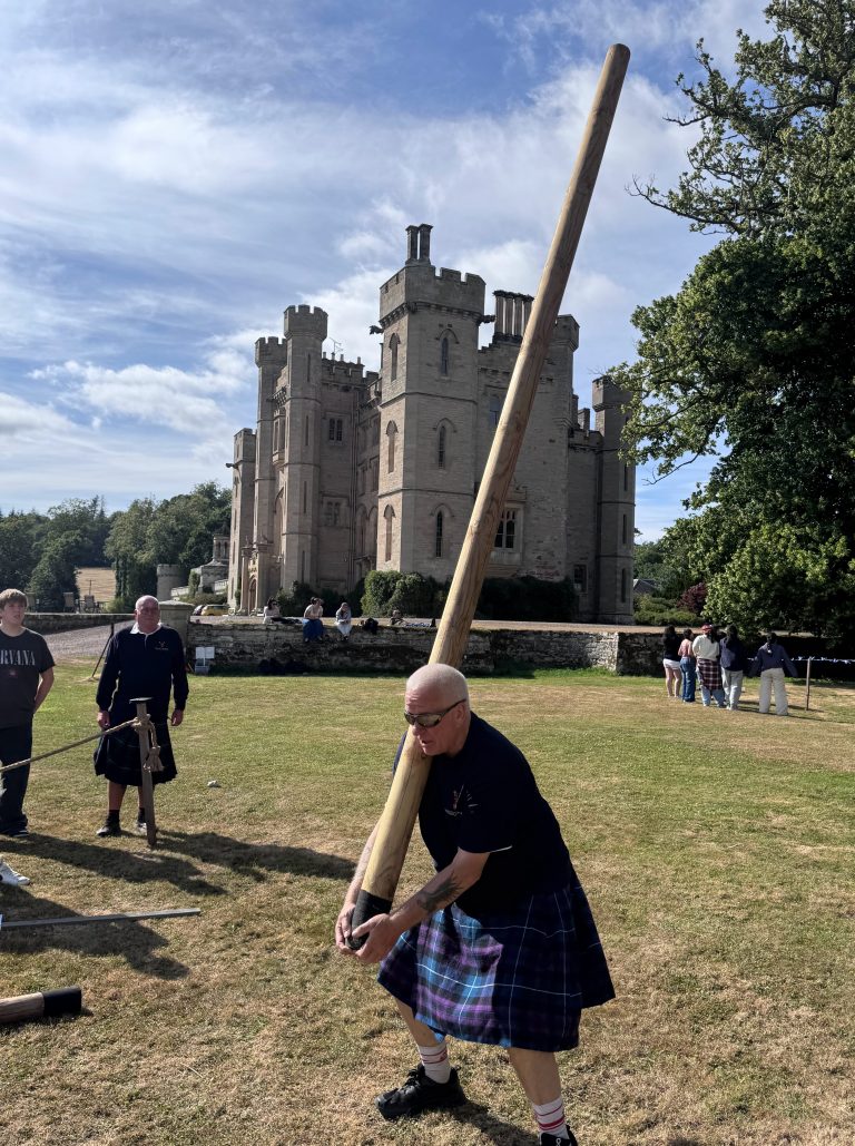 Caber Toss at a Wild Cairns Mobile Highland Games held at a Scottish castle