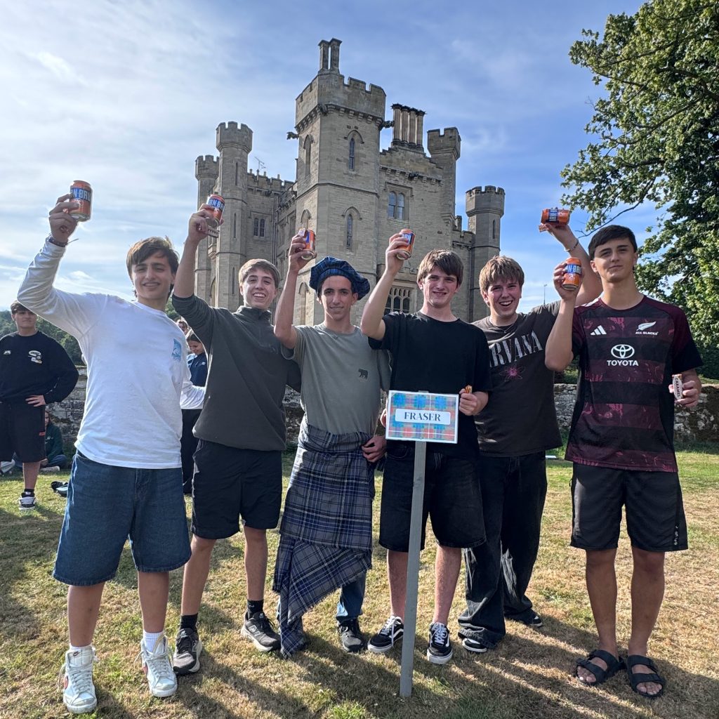 Wild Cairns Mobile Highland Games participants celebrating at a Scottish castle